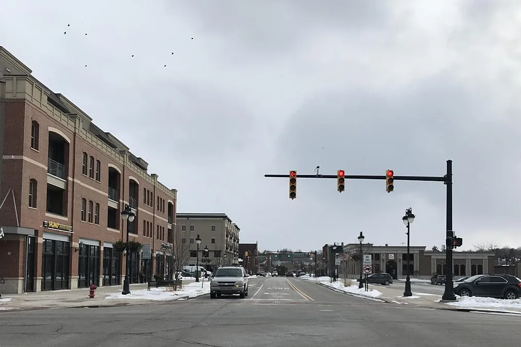 Downtown Fenton street with brick storefronts and traffic lights